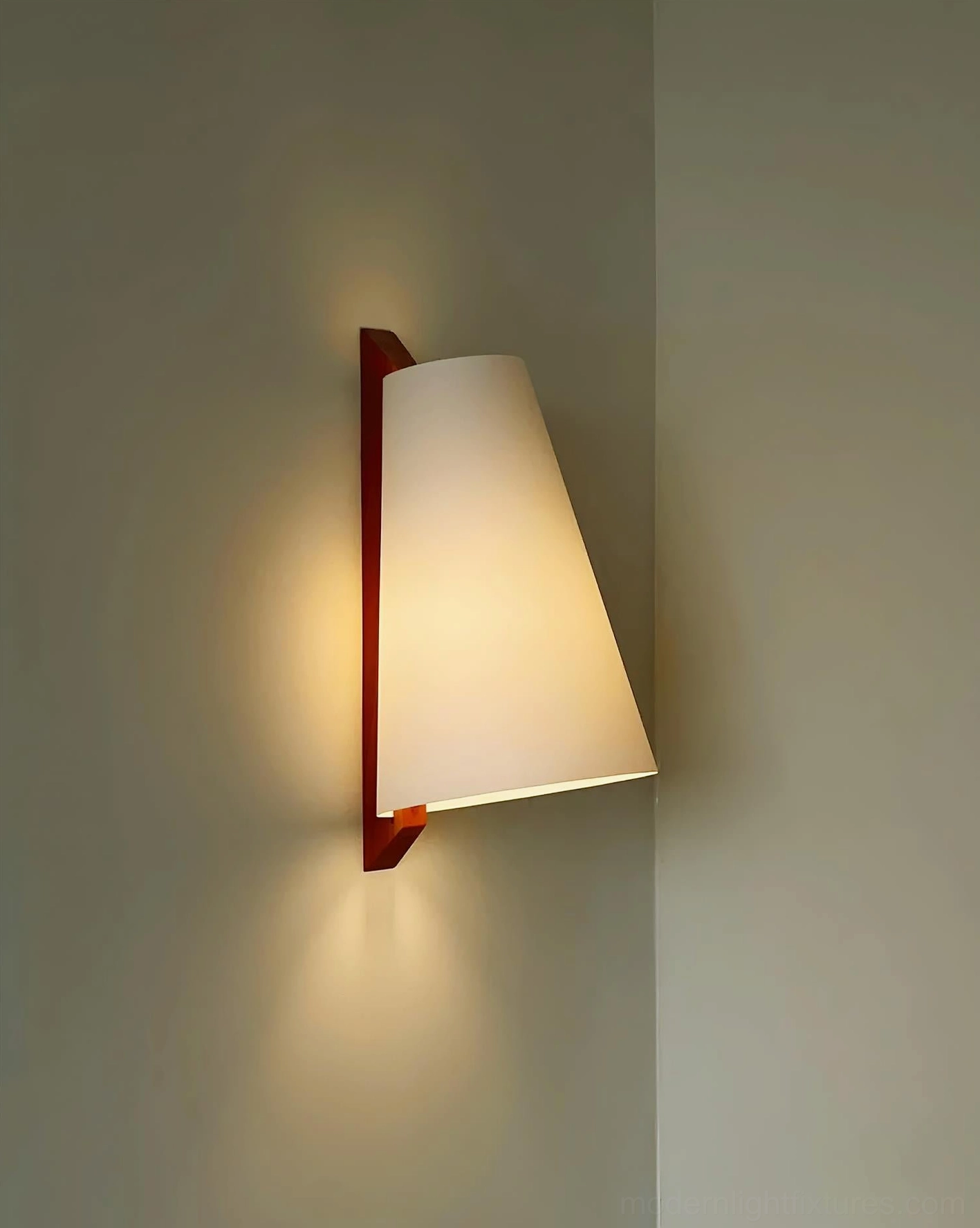 Close-up side view of illuminated Trianora geometric wall sconce with tapered white shade and brown wooden bracket