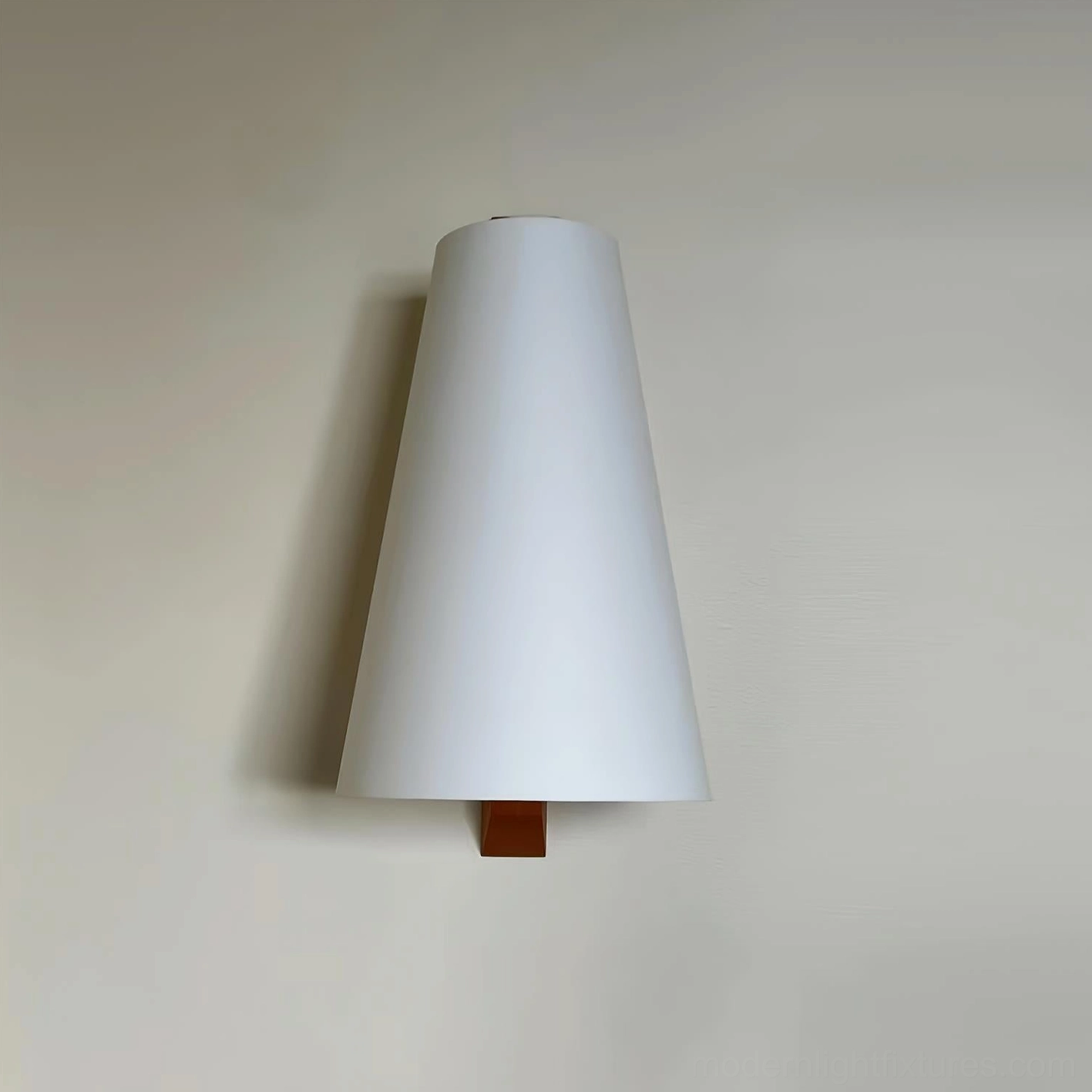 Trianora modern minimalist wall lamp mounted on warm interior wall with tall tapered white shade and compact wood base