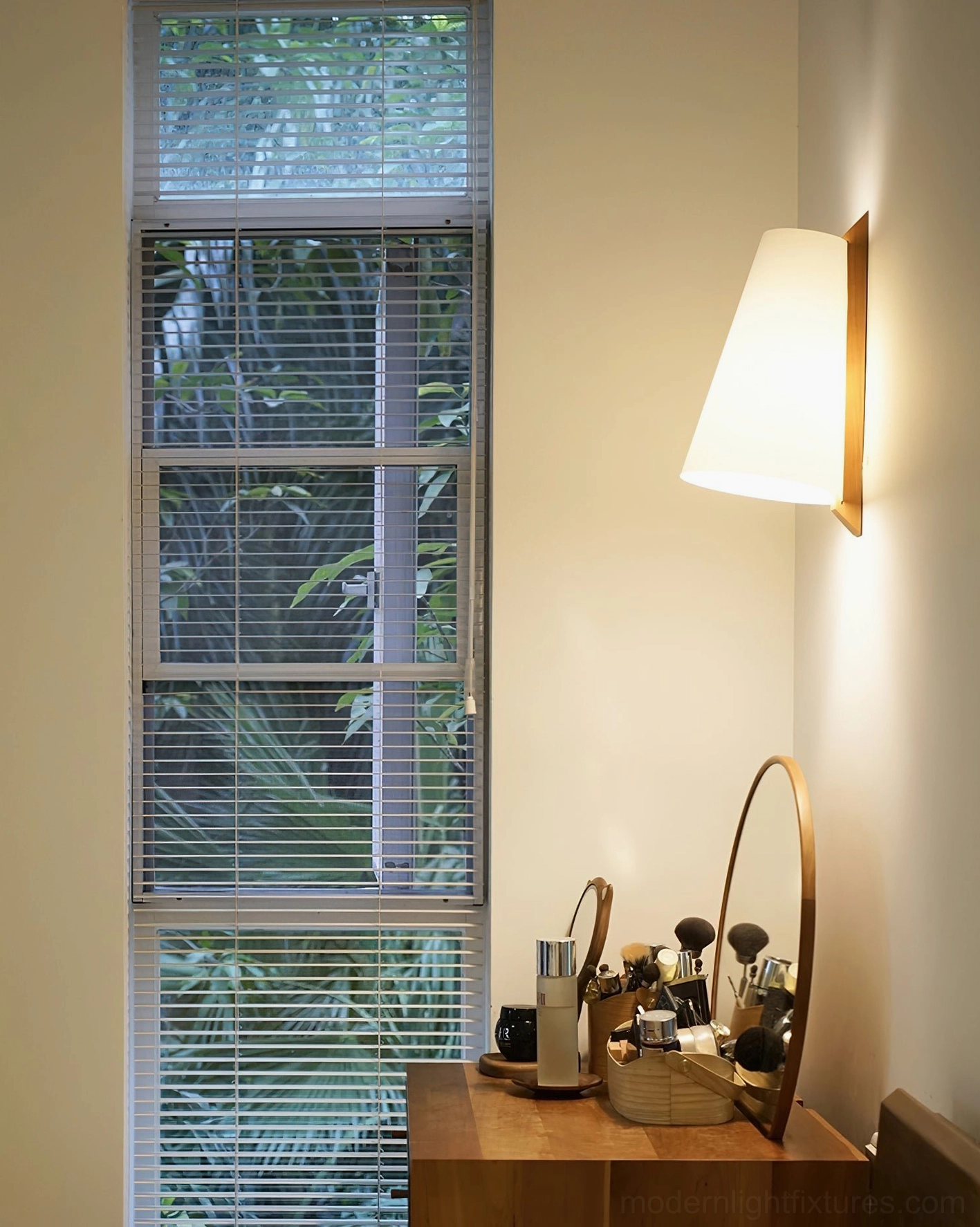 Trianora modern wall lamp providing warm ambient accent lighting in residential vanity workspace