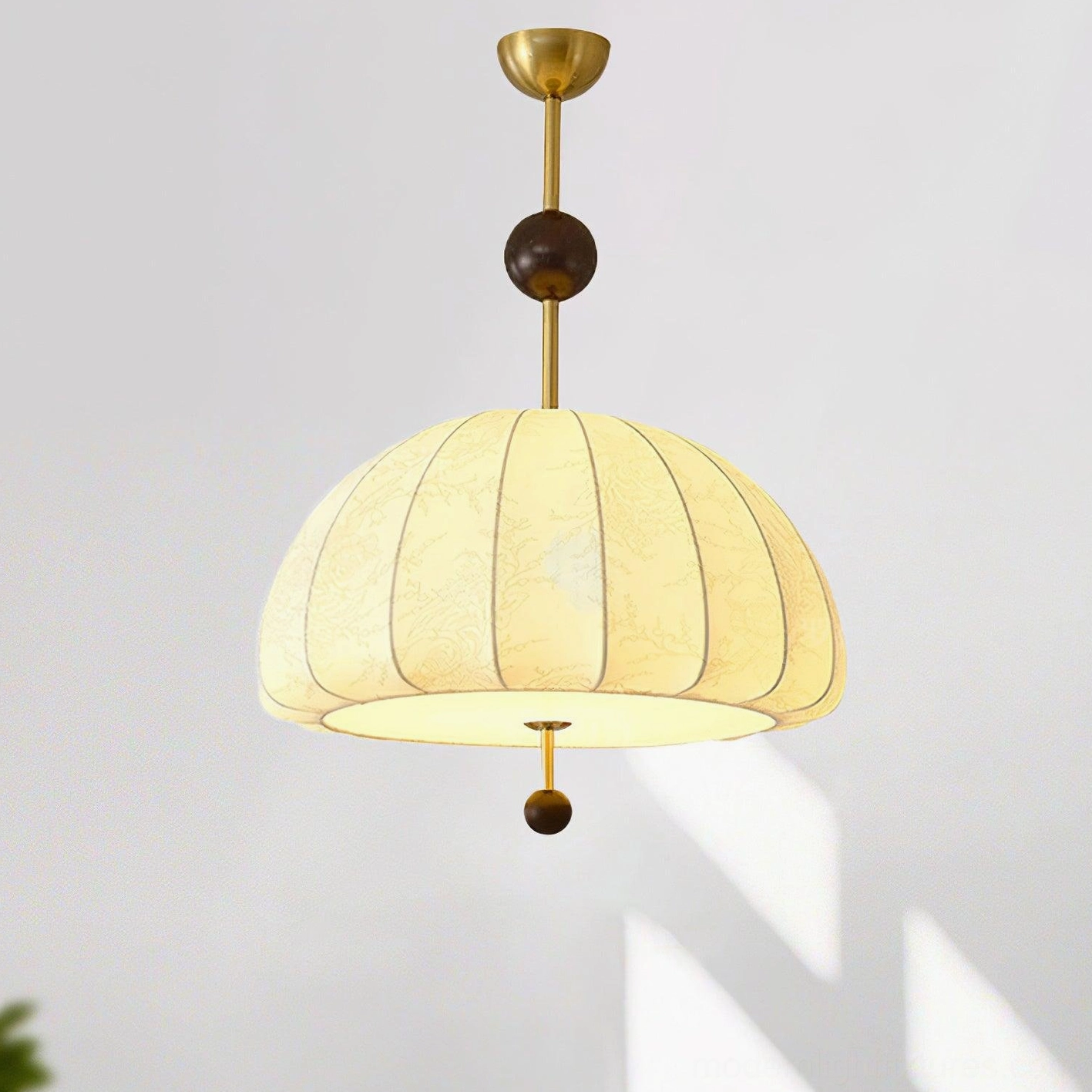 Trigg fabric dome pendant with ribbed beige shade and wood bead accent, studio shot with subtle shadow on white backdrop