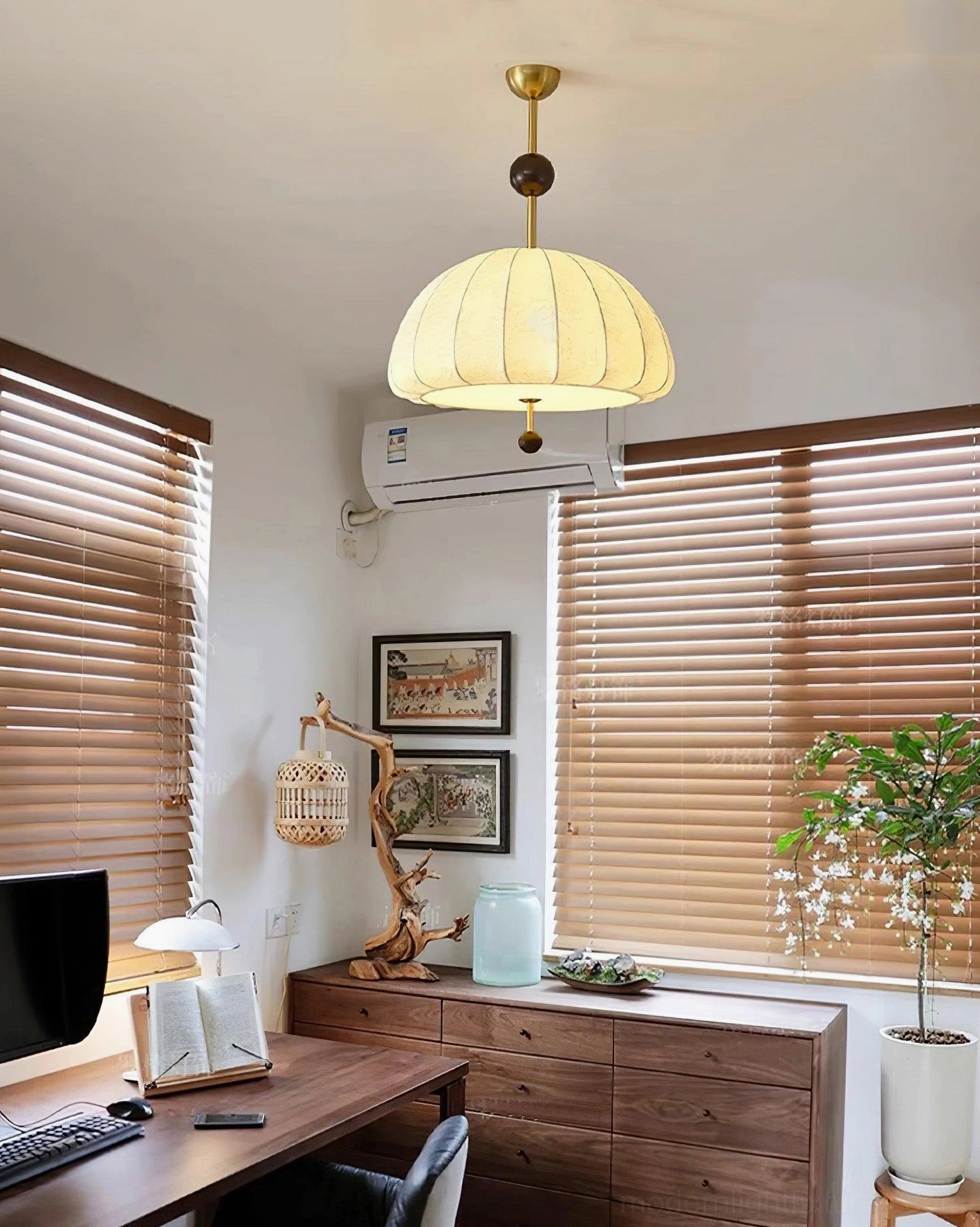 Trigg dome pendant suspended above wooden desk in home office setting with warm home office lighting and study ambiance