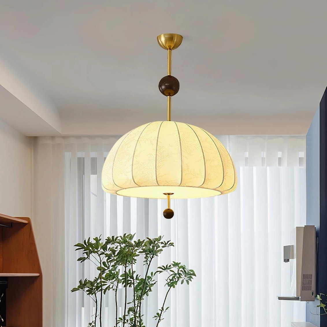 Trigg pendant light in mid-century modern interior setting with matching sand nickel hardware and contemporary furniture
