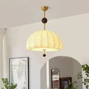 Trigg pendant light installed in warm vintage living room with neutral interior decor and soft ambient lighting from below