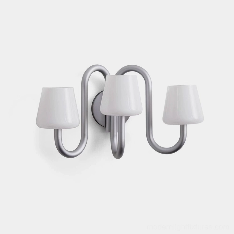 Trilo modern 3-light wall sconce with curved aluminum arms and frosted glass shades, minimalist design from top angle