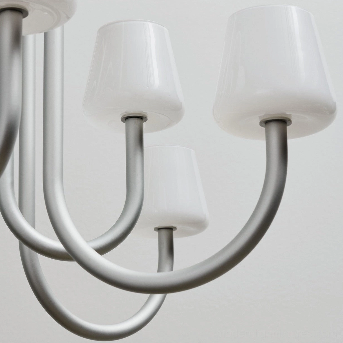 Trilo modern chandelier detail shot showing tapered white glass shade construction and metal frame