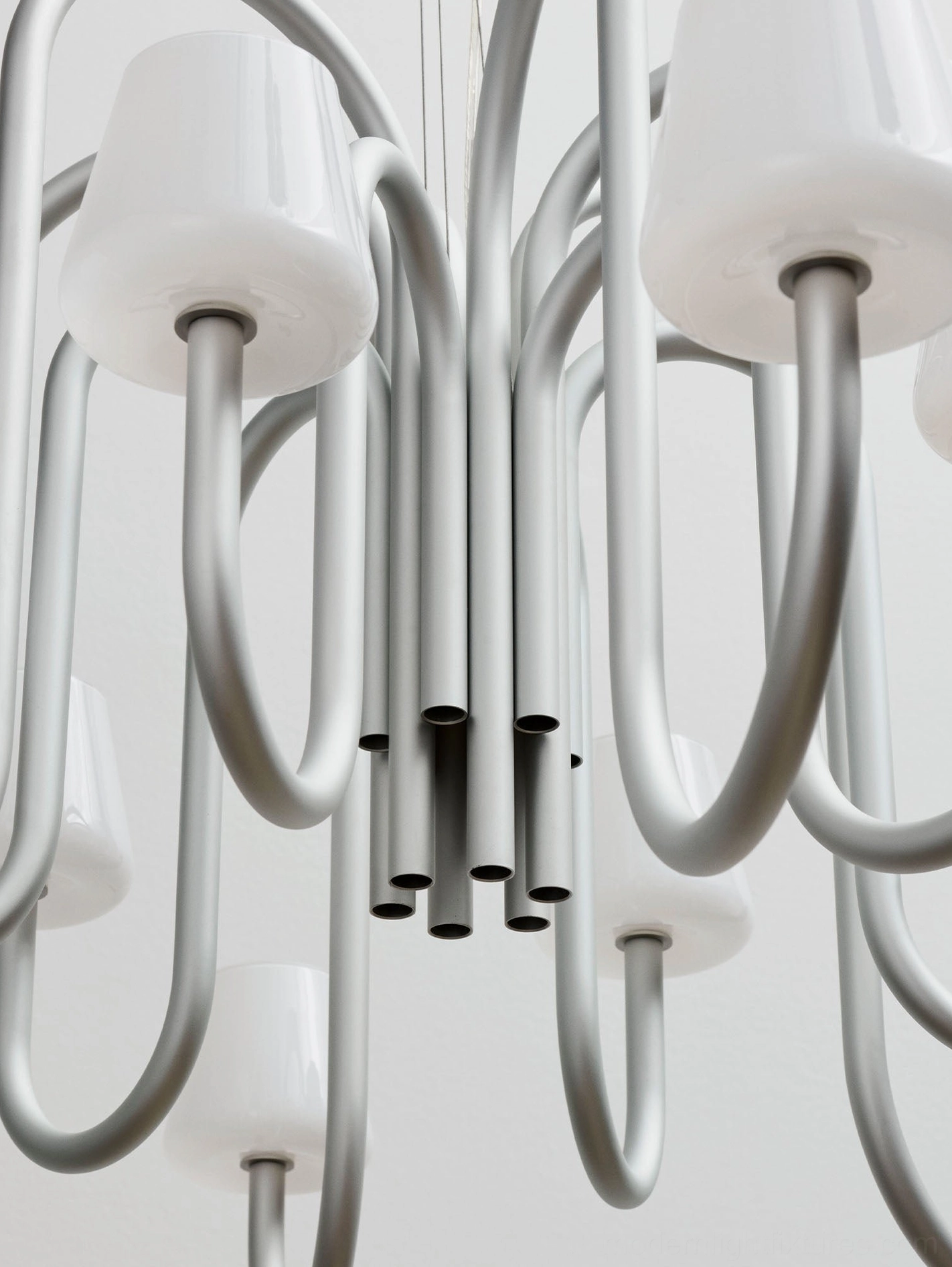 Trilo modern sculptural chandelier with curved tubular arms and frosted white glass diffusers