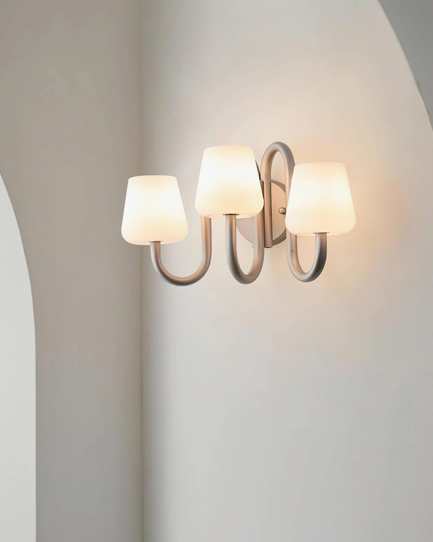 Trilo three-light wall sconce showing clean minimalist silhouette and glass diffusion