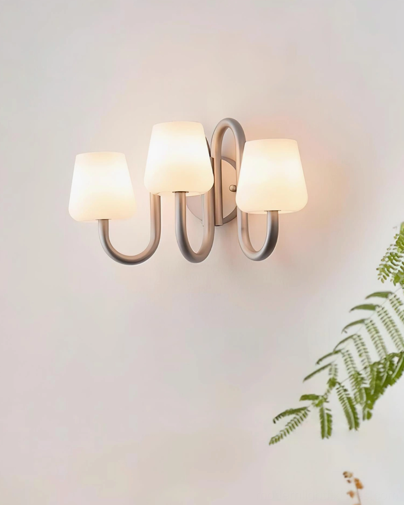 Trilo wall sconce oblique angle showing curved aluminum frame and opal glass shade details