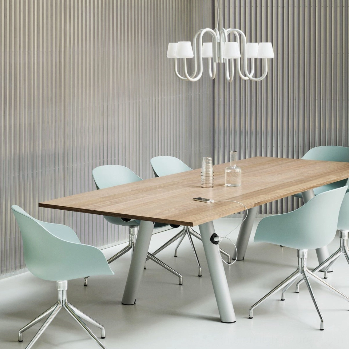 Trilo sculptural chandelier with white metal finish above wooden dining table in modern office meeting room