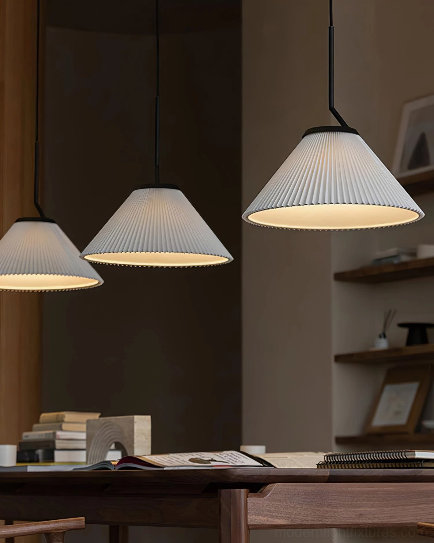 Three Nebra pleated pendant lights in workspace - contemporary minimalist lighting fixtures with black suspension rods