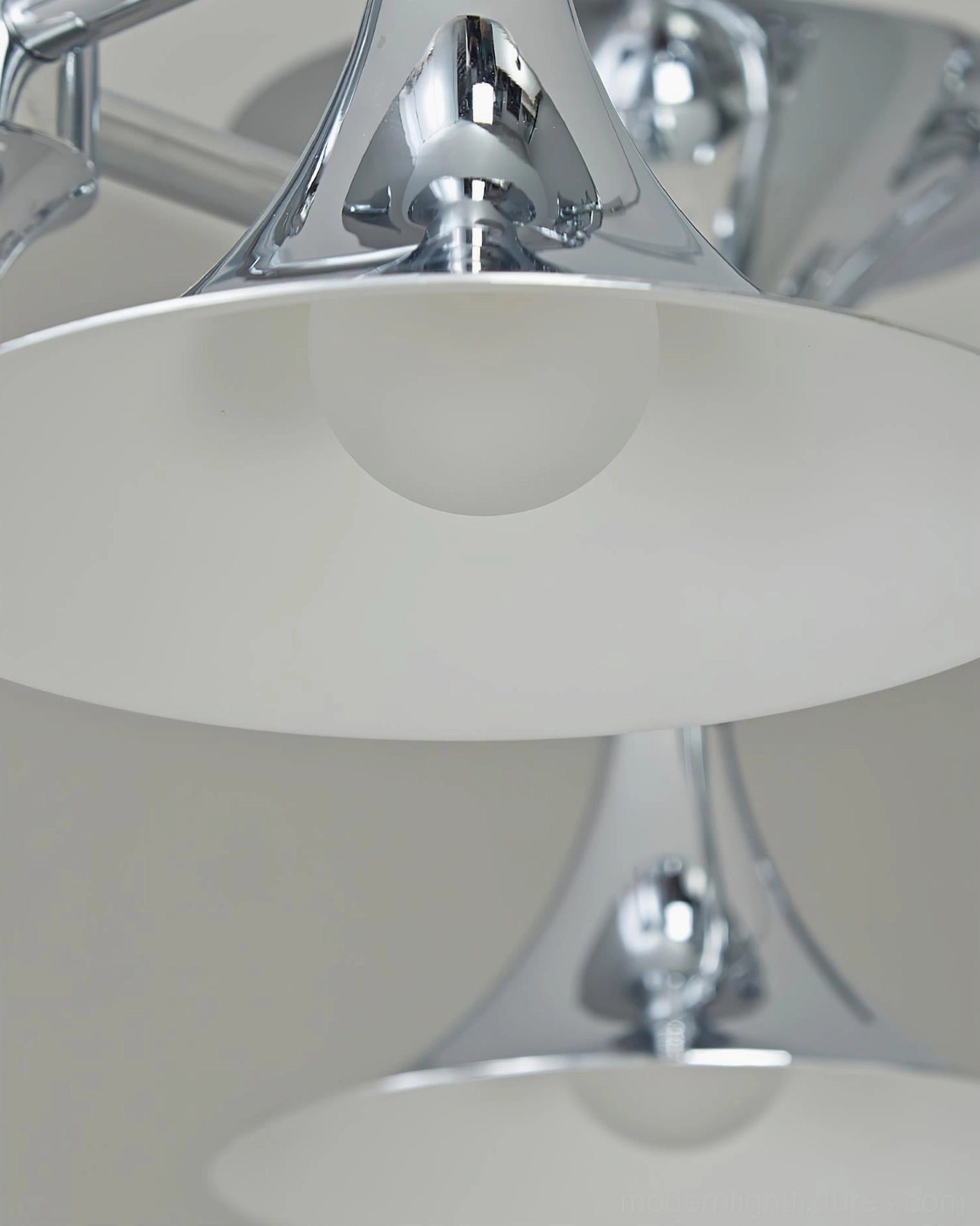 Tromelle brass-inspired chandelier with fluid curves and chrome finish in contemporary home setting