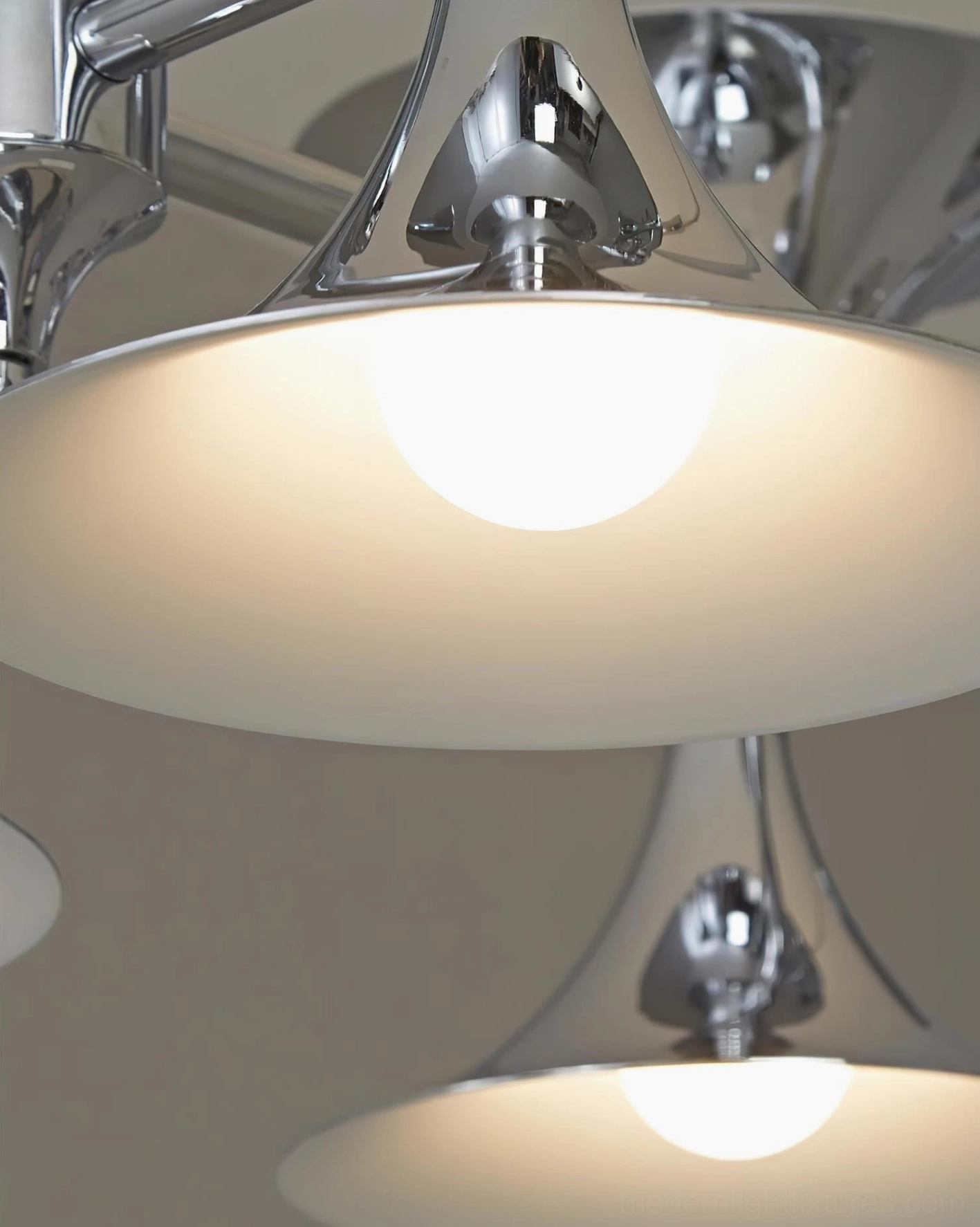 Tromelle linear chandelier contemporary design showcase with polished chrome metalwork and sculptural shades