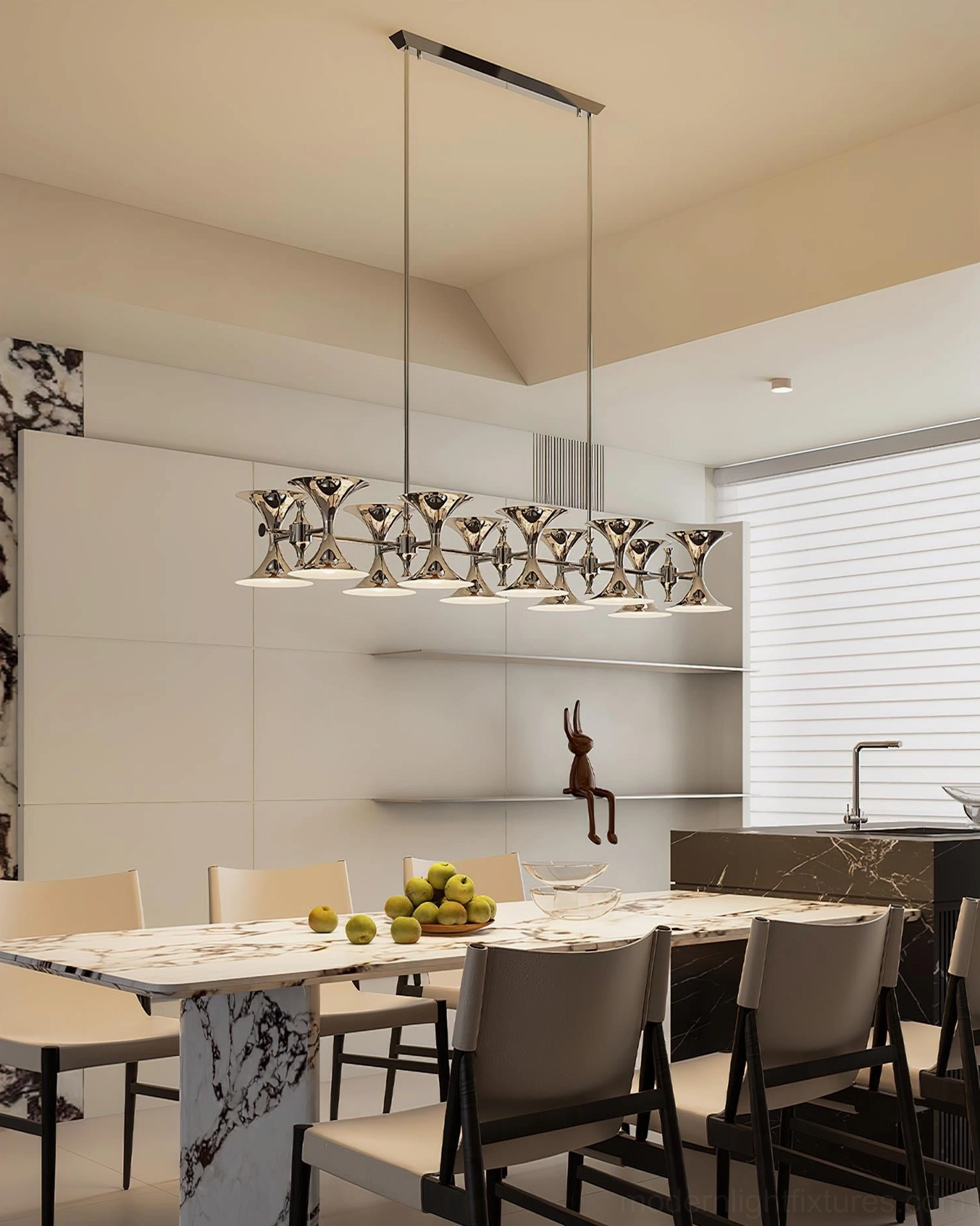 Tromelle linear chandelier three-quarter view installed above marble table in modern open-plan kitchen