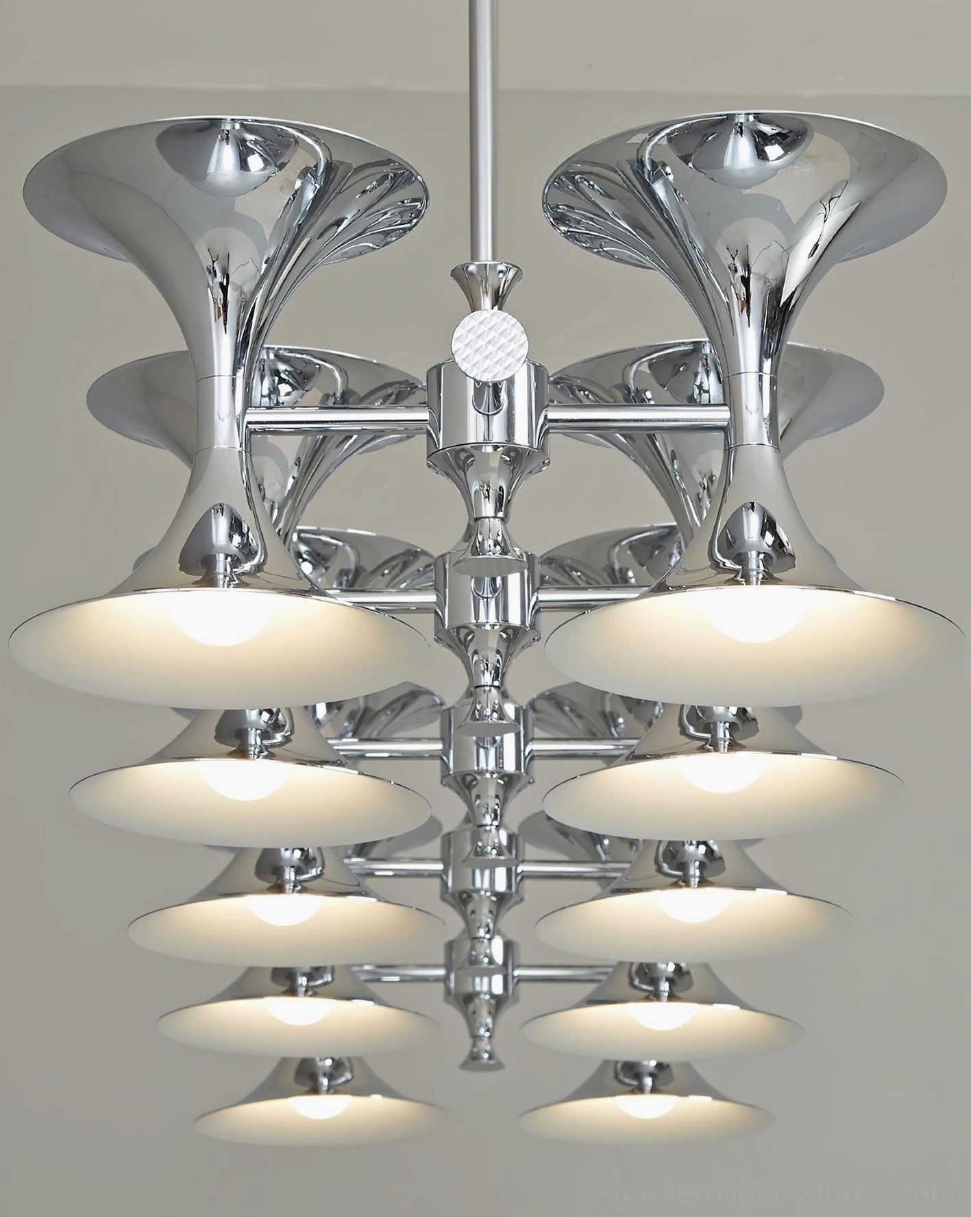 Tromelle linear pendant light with polished metal construction and disc-shaped shades in modern interior