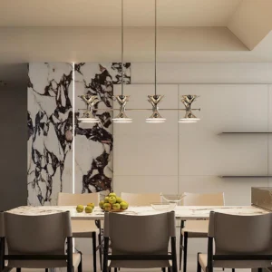 Tromelle 8-head chandelier installed in luxury modern dining room above marble table with eye-level perspective