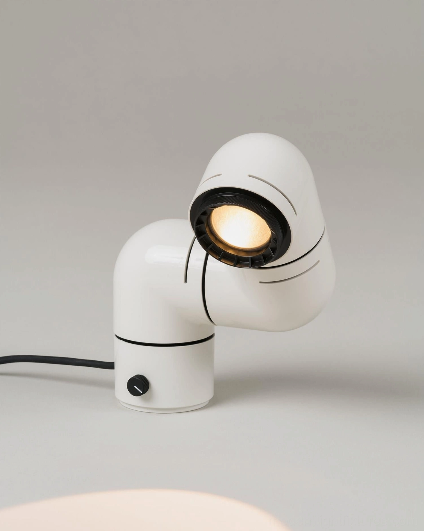 Tubular table lamp sculptural form showcasing factory-style design heritage