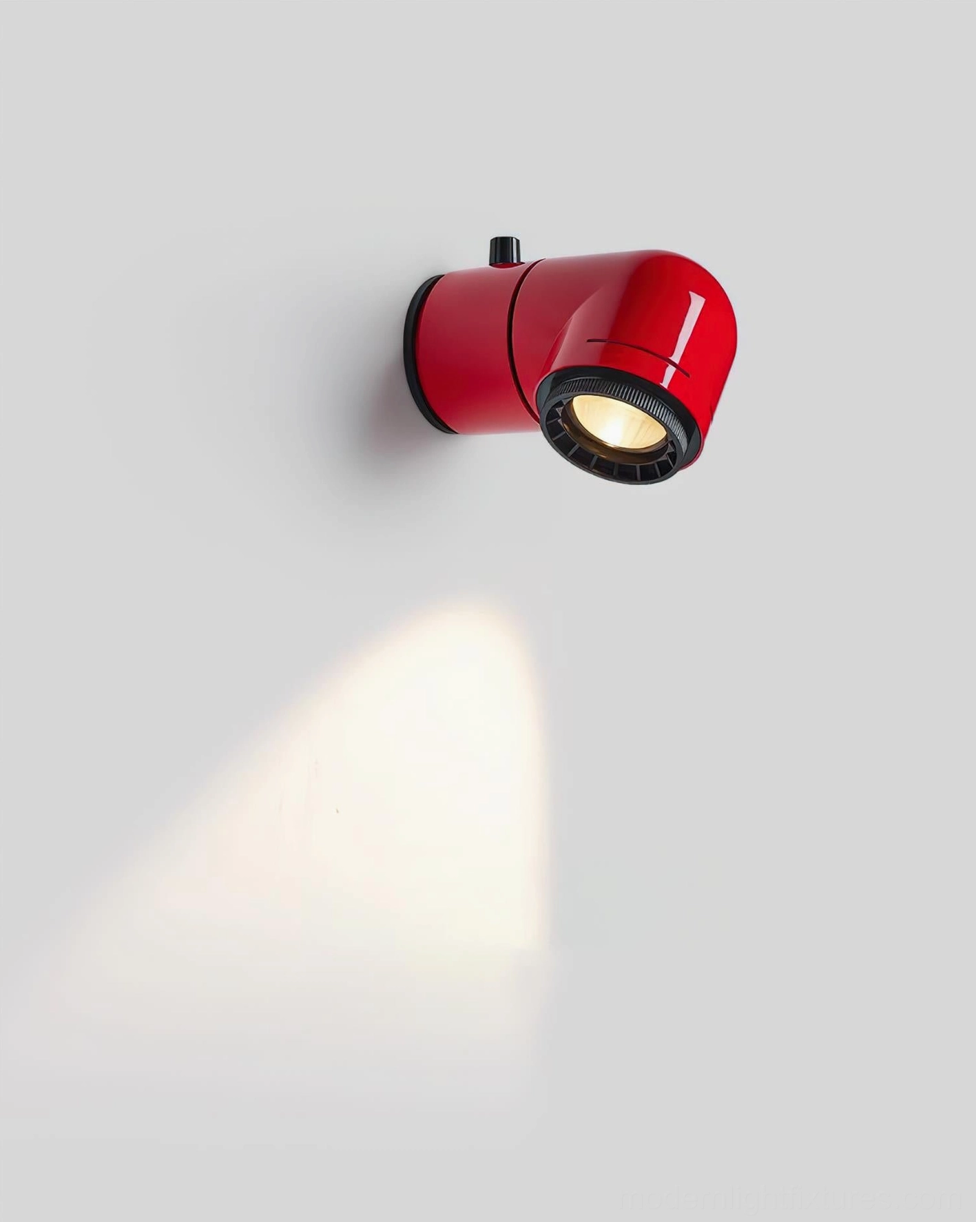 Cylindrical wall light casting warm spot light downward, showcasing directional beam capability