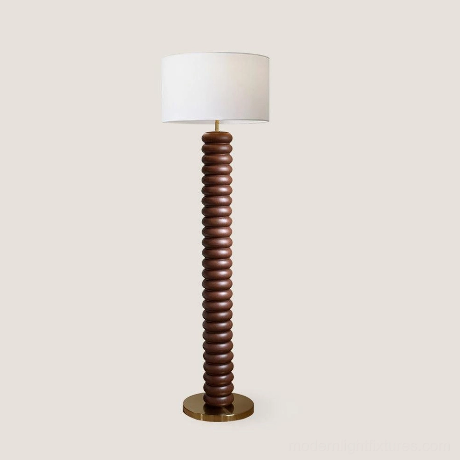Walnut color ribbed wood Tula Twist floor lamp with brass metallic base and warm fabric shade, product showcase