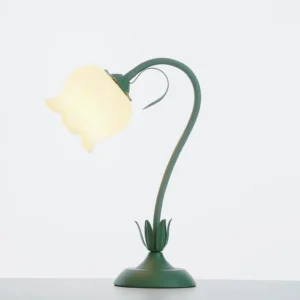 Lit twist tulip flower lamp showing warm illumination through frosted glass shade with curved metal stem