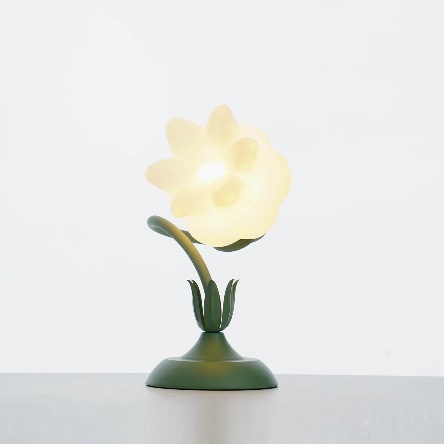 Twist tulip table lamp creating warm white illumination in bedroom setting