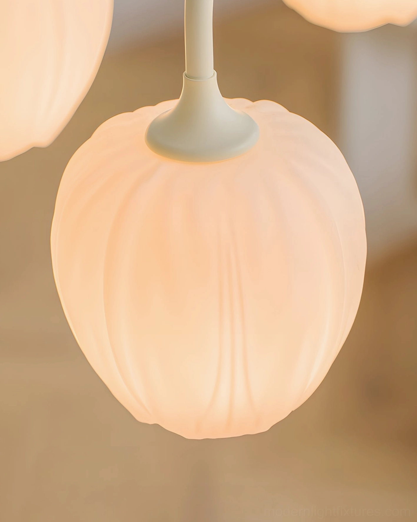 Modern tulip glass chandelier installation showing adjustable chain hanging system