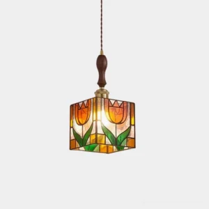 Tulip stained glass pendant light with hand-crafted amber and green glass panels, brass hardware, and walnut wood accent detail in studio front view