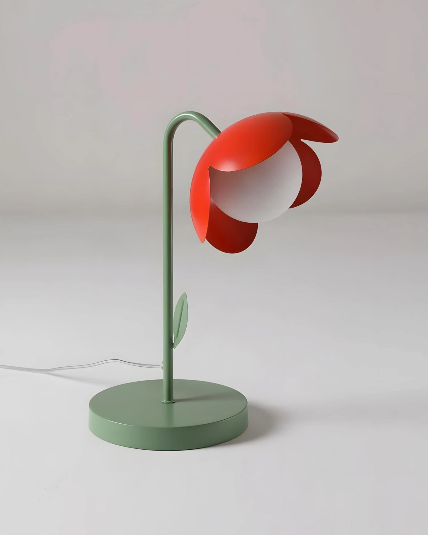 Tulira botanical table lamp close-up showing red petal shade with round glass diffuser and green metal base