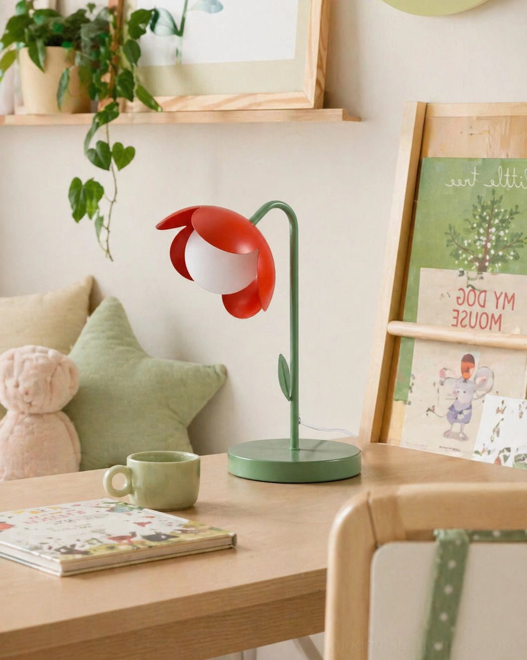 Red tulip table lamp displayed on children's study desk with plush toys and books - botanical kids room lighting