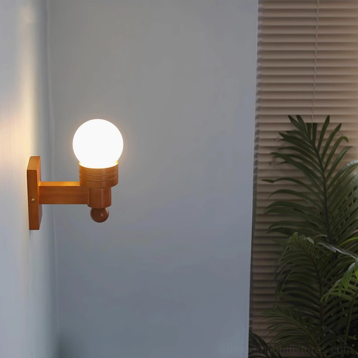Tupelo wall sconce spherical shade design in frosted white glass with mid-century aesthetic appeal
