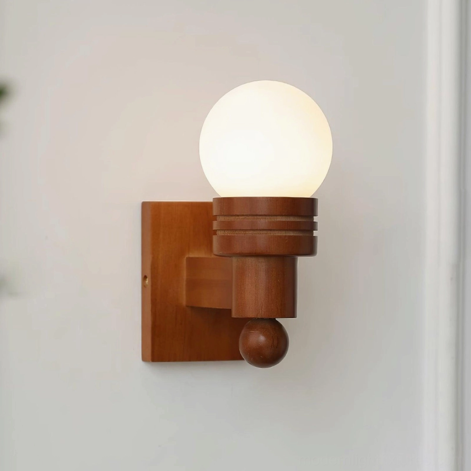 Tupelo wall sconce wooden construction and frosted shade assembly in detailed product photography