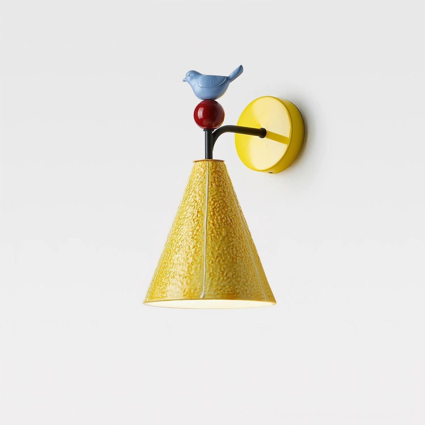 Tweetie bird ceramic wall sconce yellow with visible warm ambient glow and decorative bird ornament accent