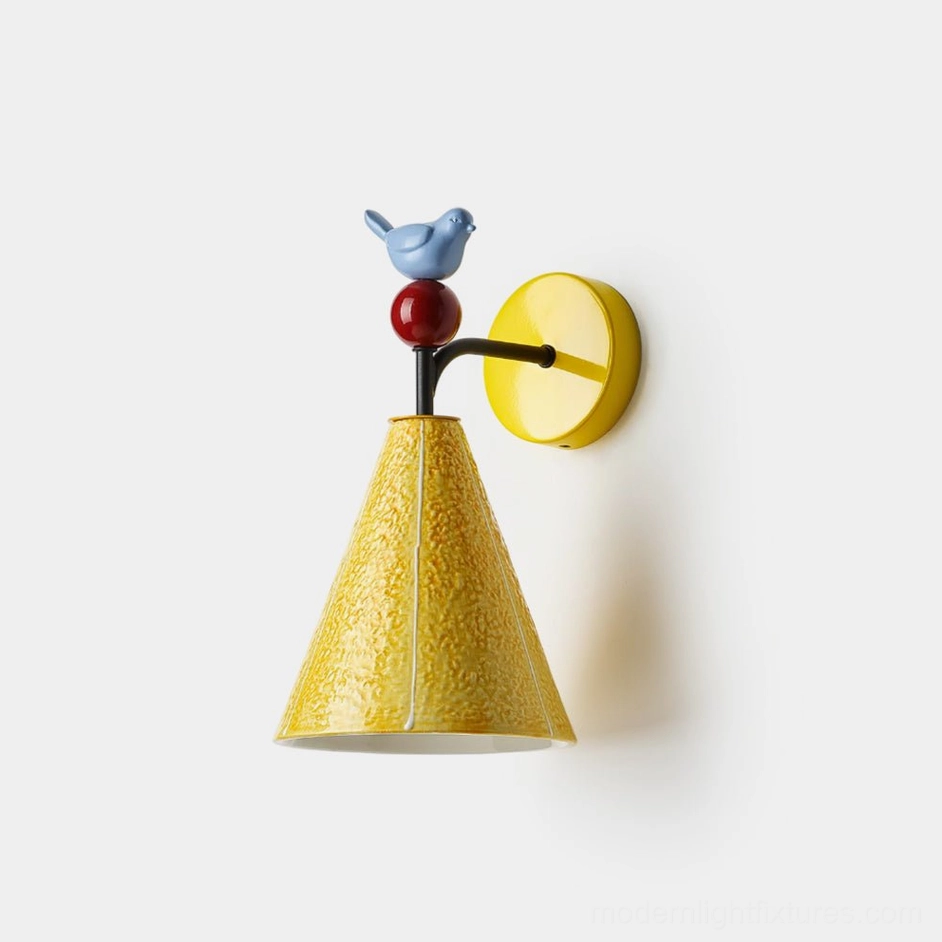 Tweetie bird wall sconce with yellow textured conical shade and blue ceramic bird ornament, front view on white background