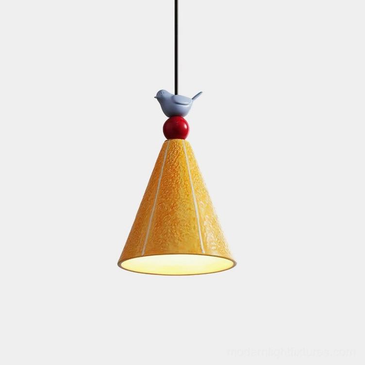Tweetie ceramic pendant lamp with bird finial illuminated from below against white background, showing cone-shaped shade and glossy sphere base in Nordic style
