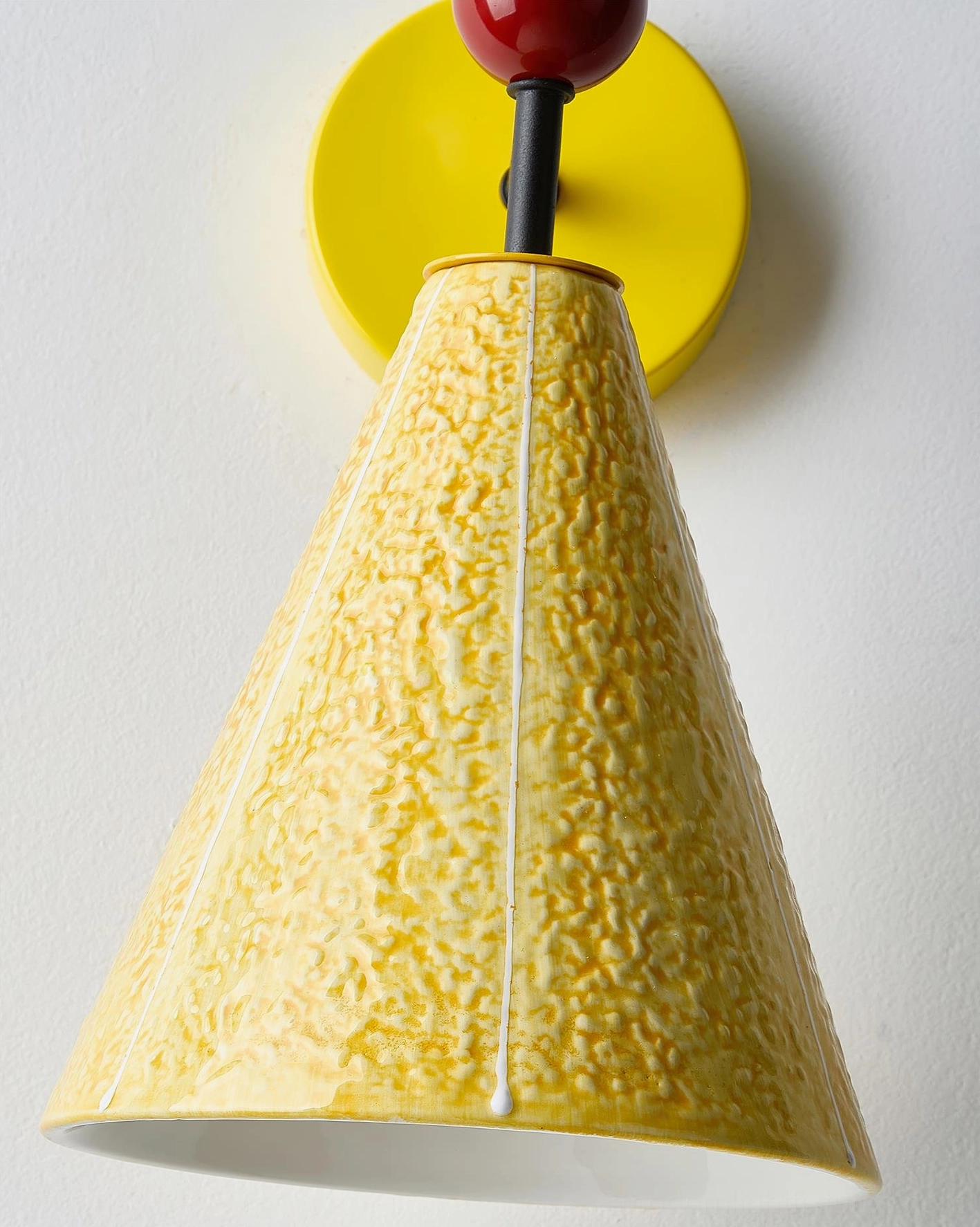 Ceramic bird wall lamp with yellow conical lampshade and playful ornament, minimalist modern aesthetic