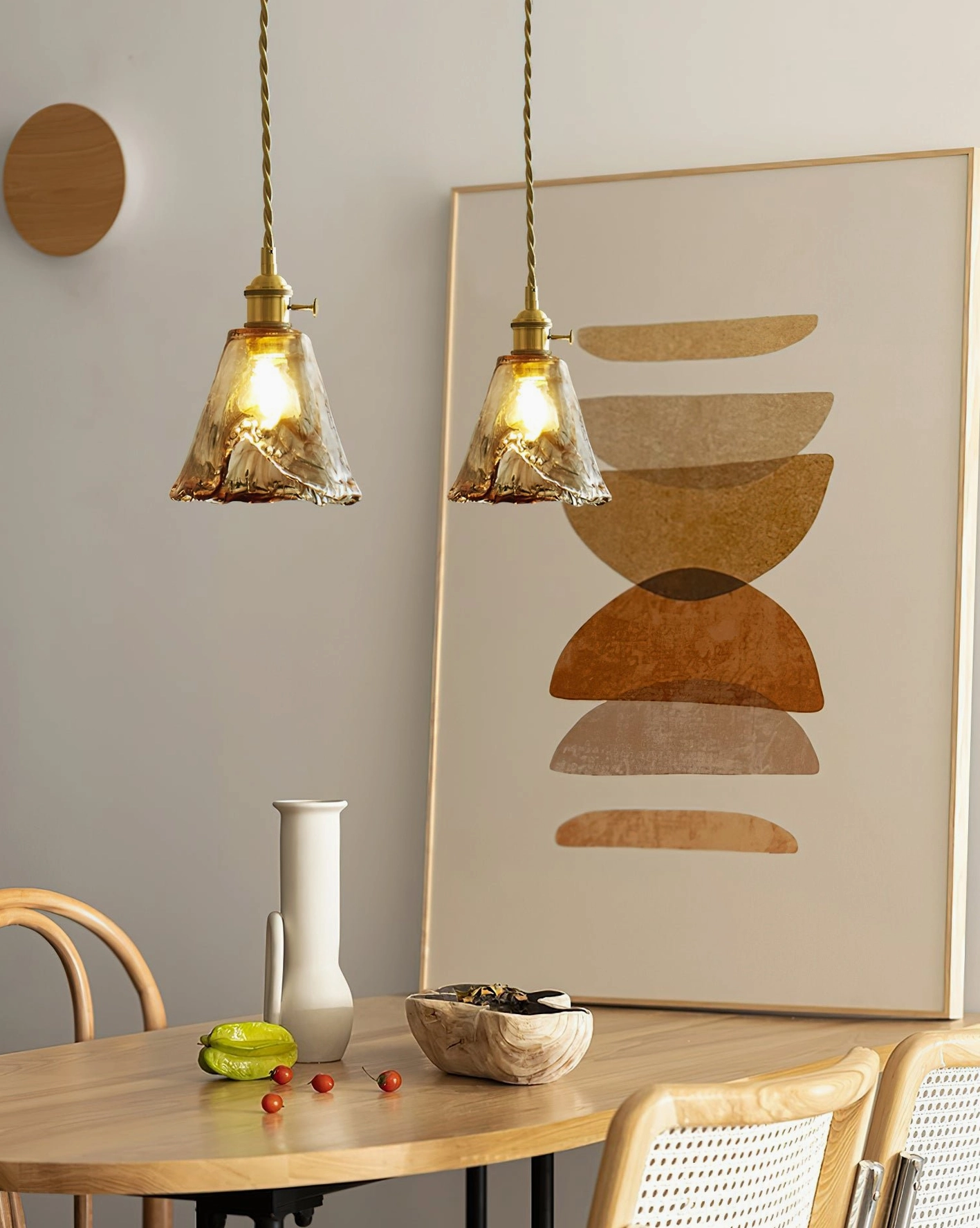 Twin amber glass cone pendant lamps in wooden dining nook - warm vintage lighting
