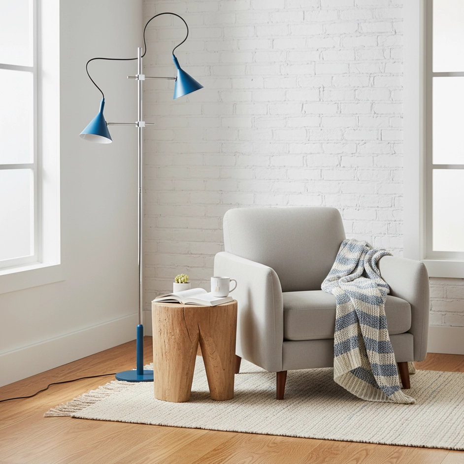 Dual-shade modern floor lamp in blue with adjustable conical heads positioned in contemporary living room next to fabric armchair