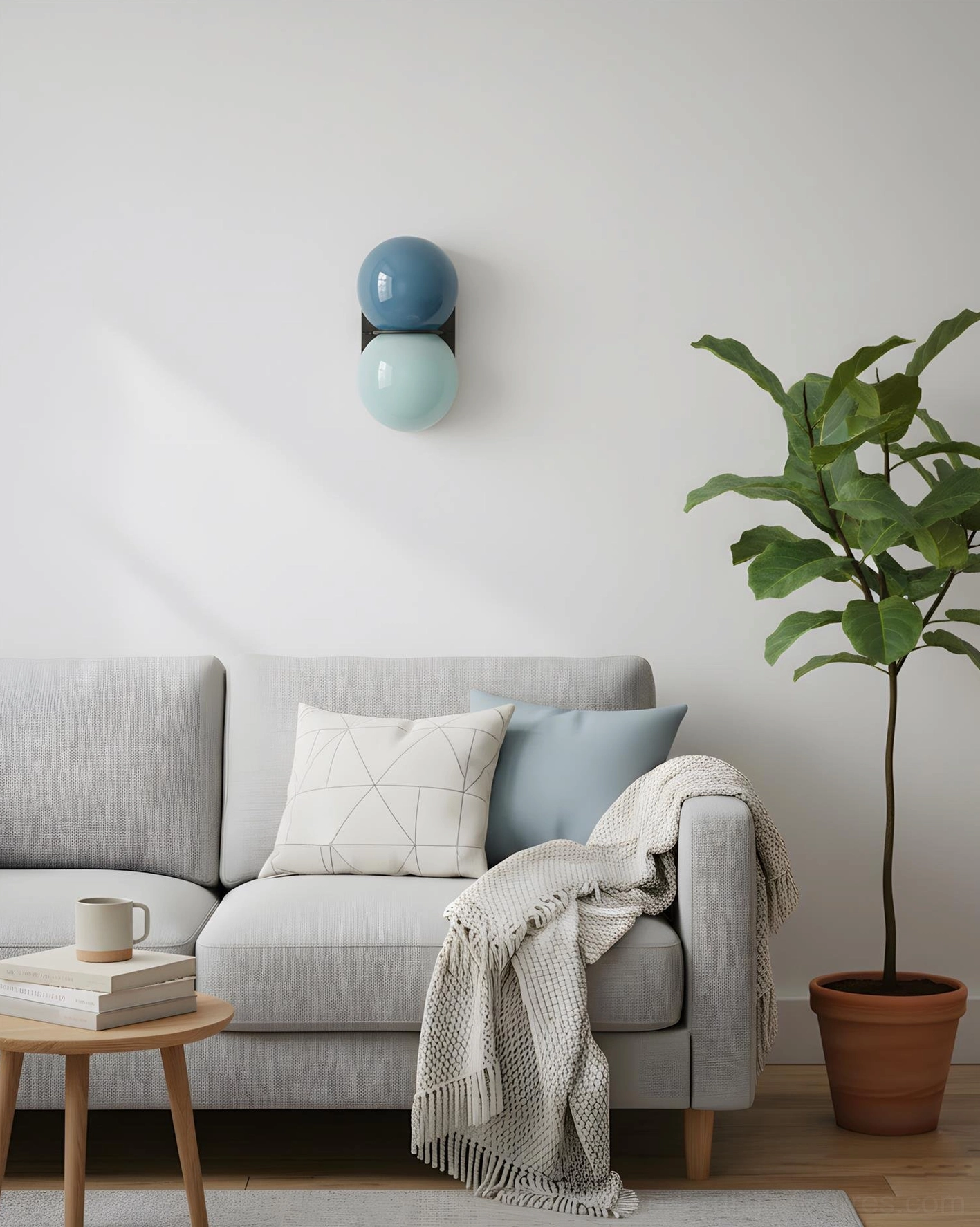 Twinwave double globe wall sconce mounted on living room accent wall beside gray sofa with green plant