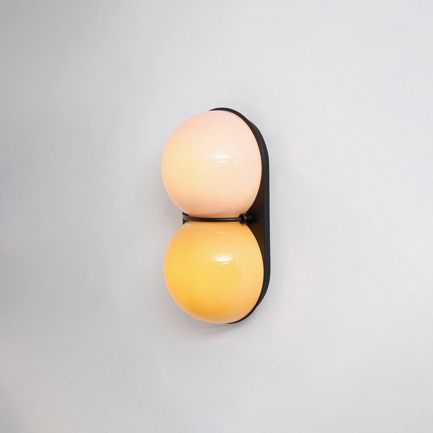 Twinwave wall sconce fixture showcasing wave-inspired dual glass sphere design detail