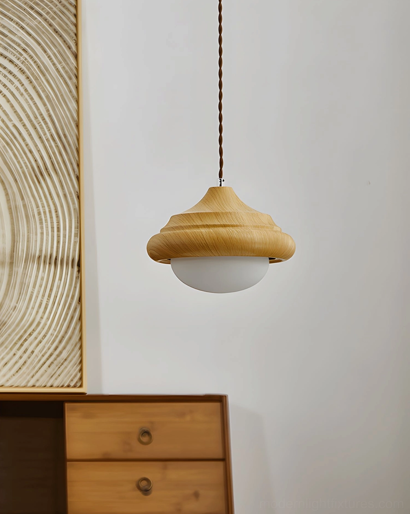 Twirl pendant light hanging in bedroom entryway with warm wooden dresser, creating cozy neutral decor ambiance
