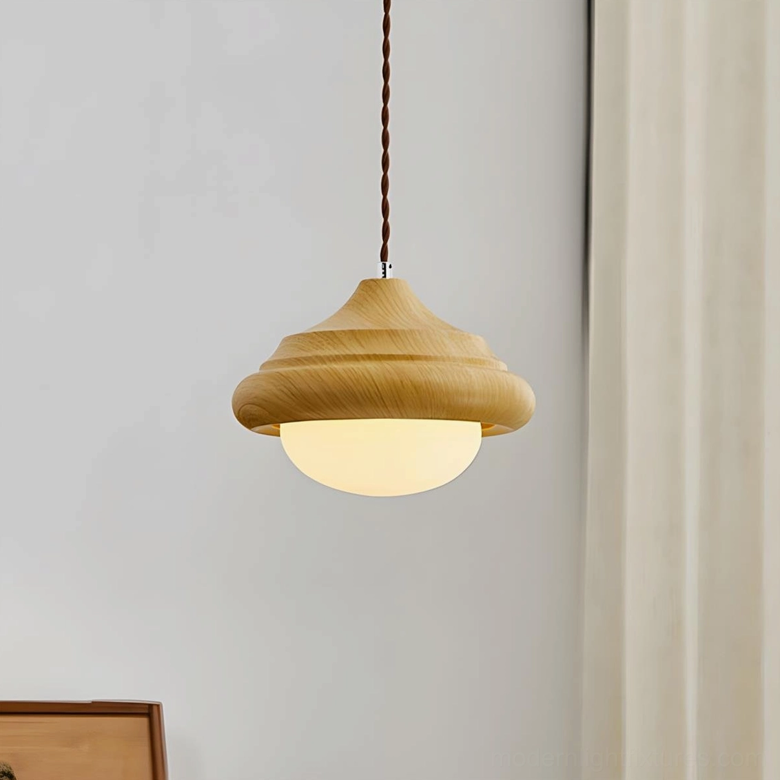Side view of twirl pendant light showing layered design and frosted glass diffuser in home corner setting