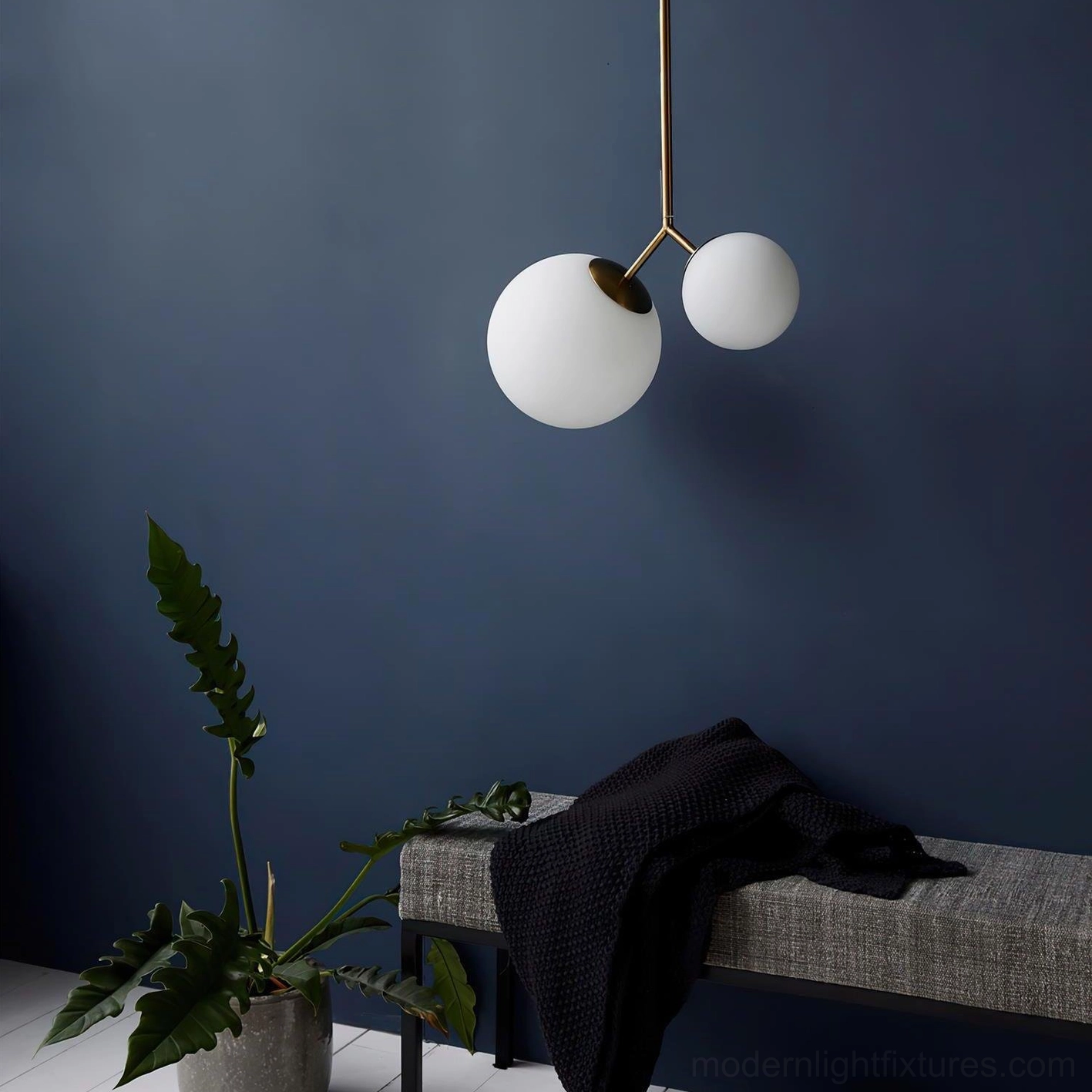 Twis dual-globe modern pendant light with brass finish and frosted white glass shades in contemporary interior space