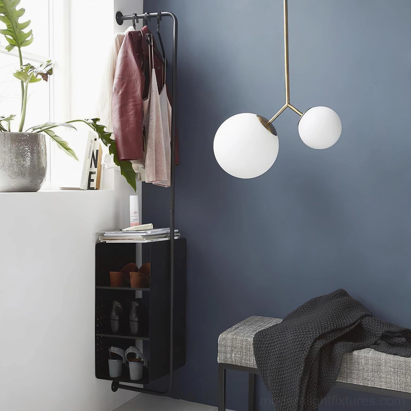 Twis dual-globe pendant light with brass frame and frosted white glass shades installed in contemporary Nordic entryway