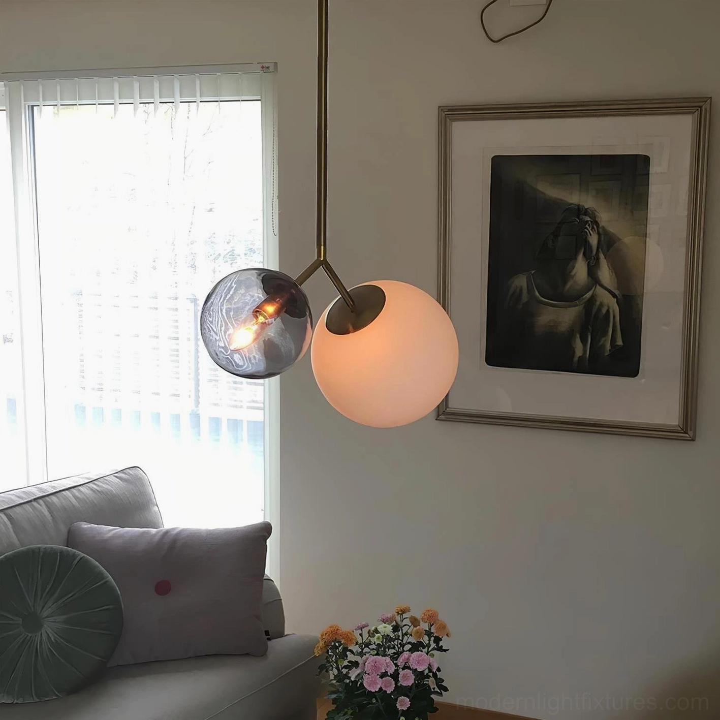 Twis contemporary dual-head pendant lamp with brass frame and frosted glass shades illuminated in cozy Nordic living room