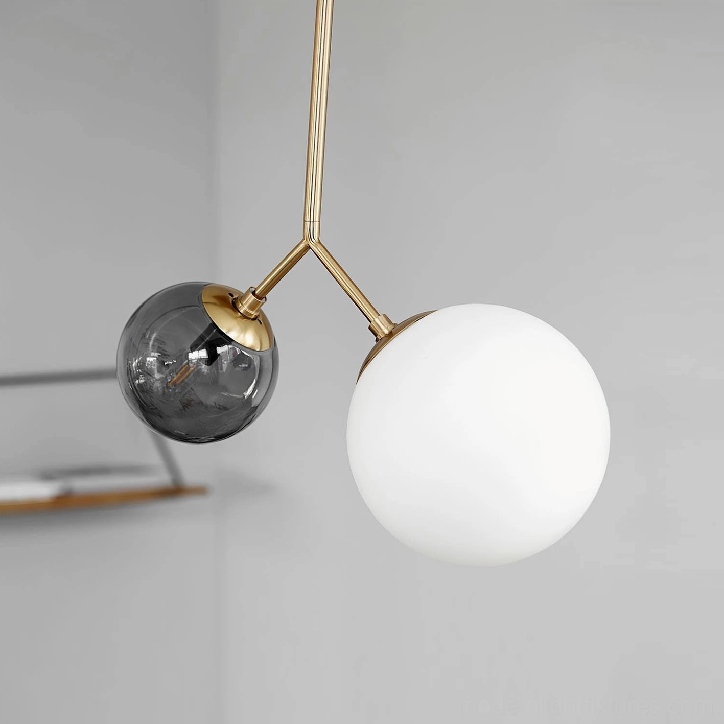 Twis contemporary two-head glass globe pendant fixture with brass hardware and frosted white and smoke gray shades in modern home interior