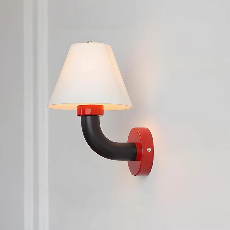 Twist Shine wall sconce with cherry red base and black curved arm installed in contemporary home interior