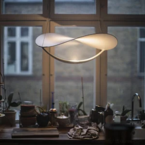 Contemporary twisted pendant lamp suspended over kitchen countertop, warm 3000K LED lighting creating ambient illumination in residential kitchen