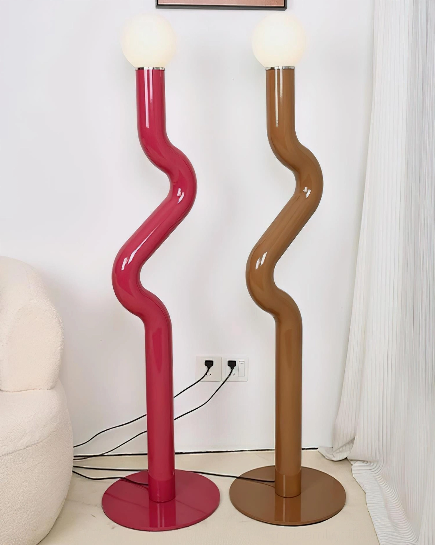 Twistie floor lamp artistic design showcasing organic curved metal structure and frosted glass diffuser