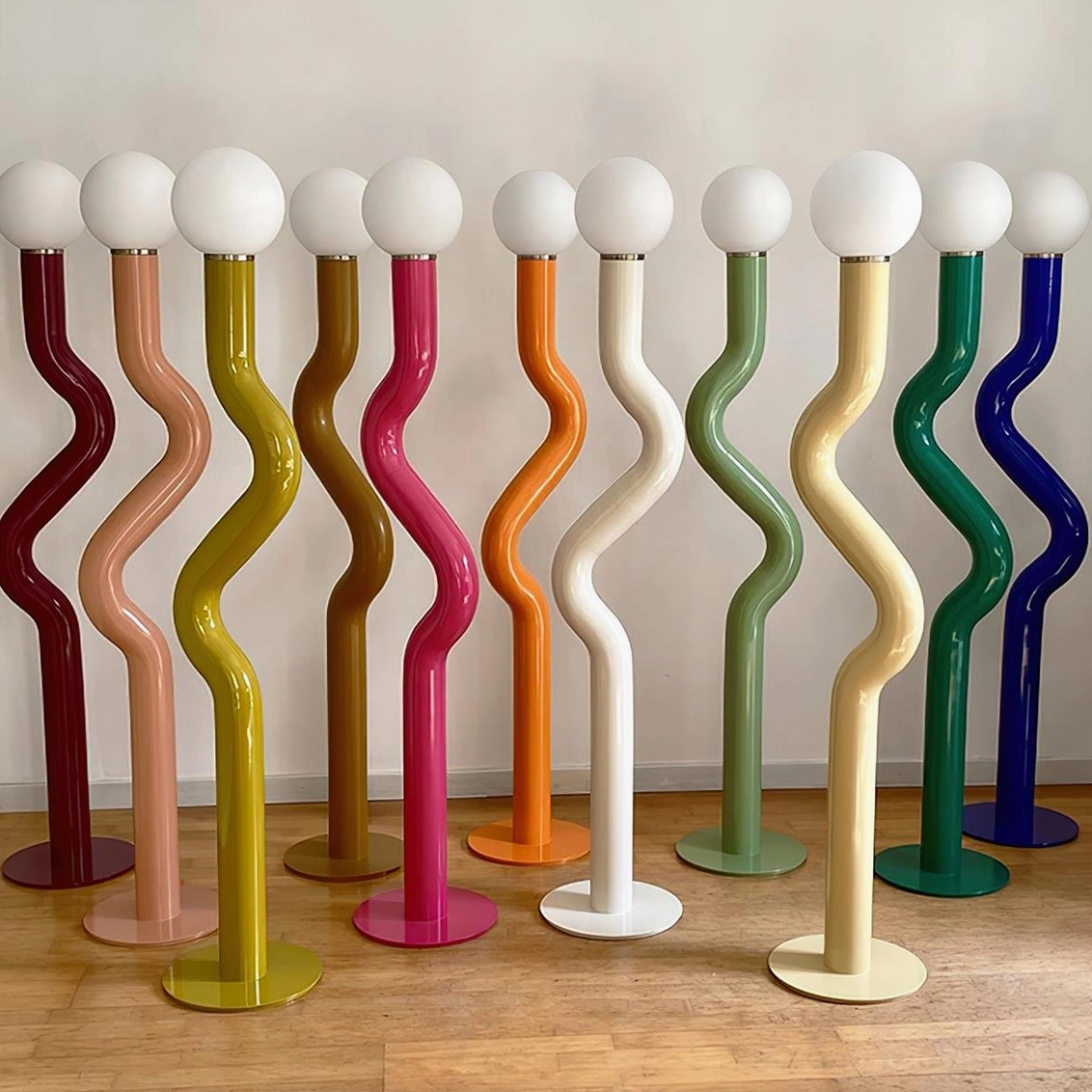 Full collection of Twistie floor lamps displaying ten plus color options on wooden floor display
