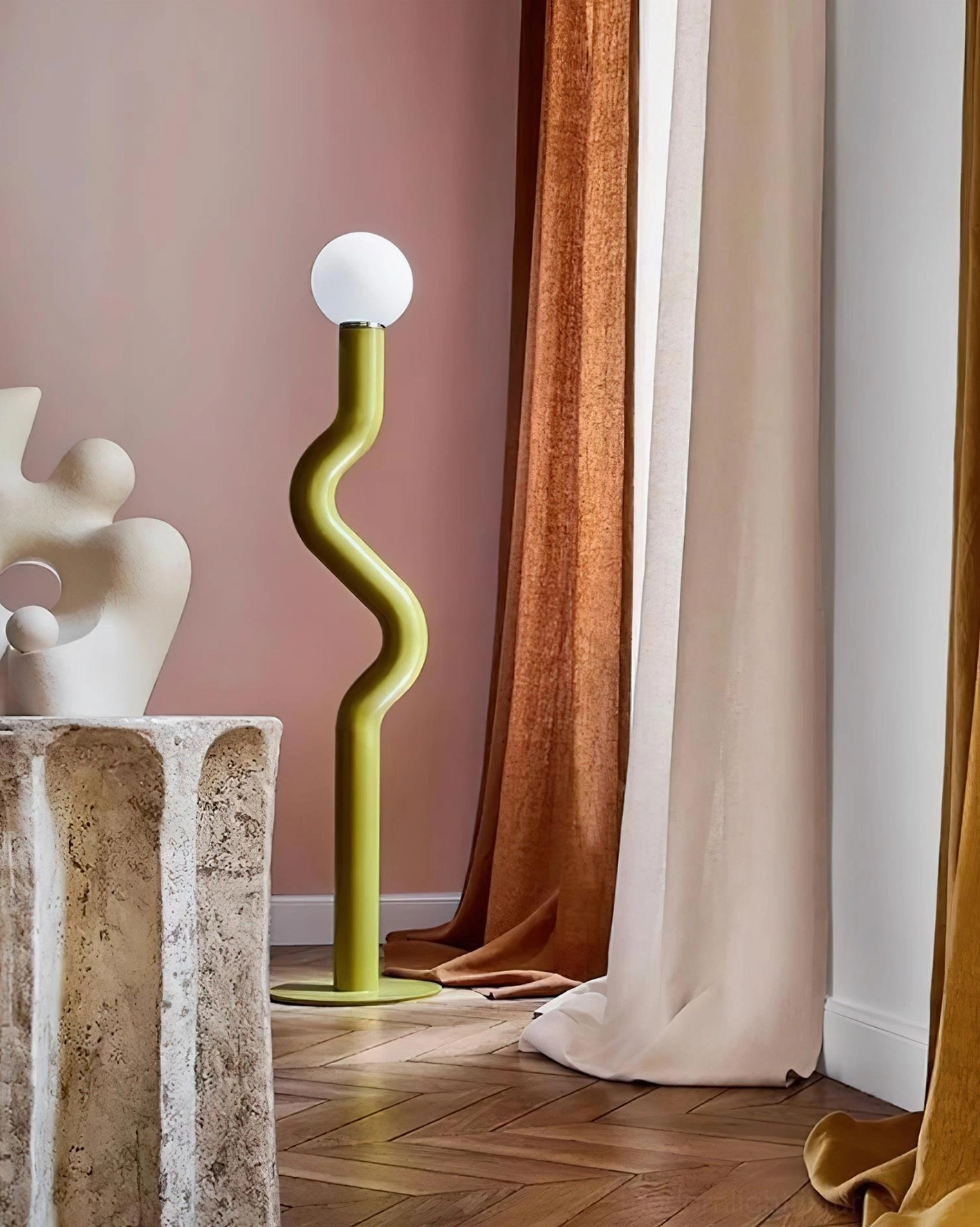 Sage green Twistie sculptural floor lamp with wavy pole and frosted globe diffuser in bohemian interior