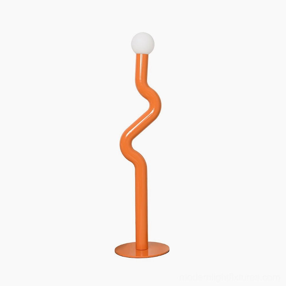 Twistie floor lamp in bright orange demonstrating kinetic sculptural design in modern studio space